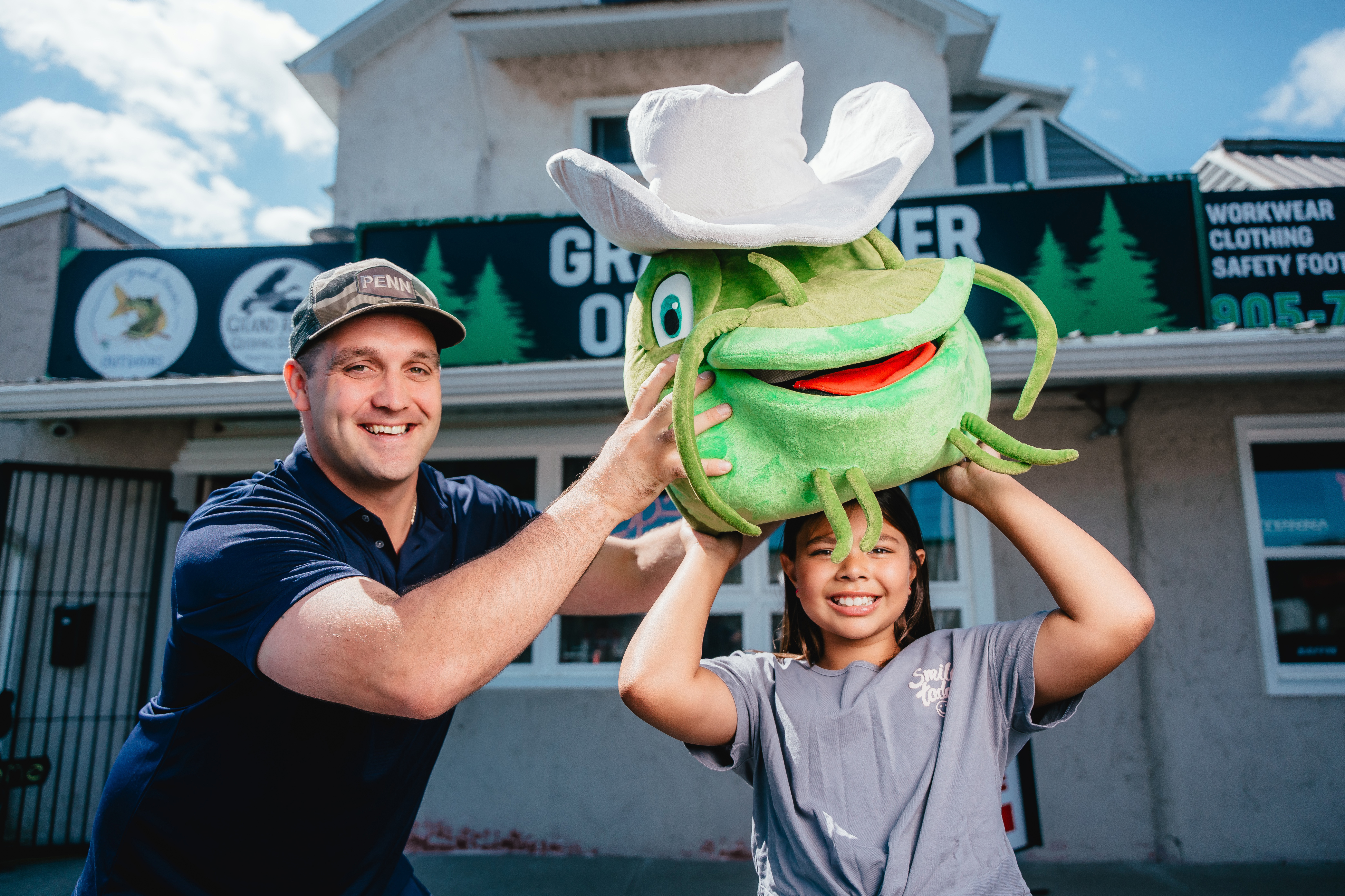 little girl with a mudcat stuffed animal on her head 