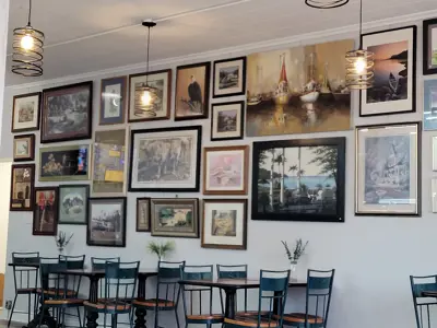 a row of coffee tables in front of art wall