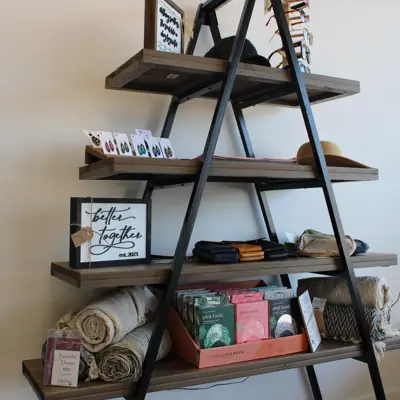 blankets and signs displayed on a shelf