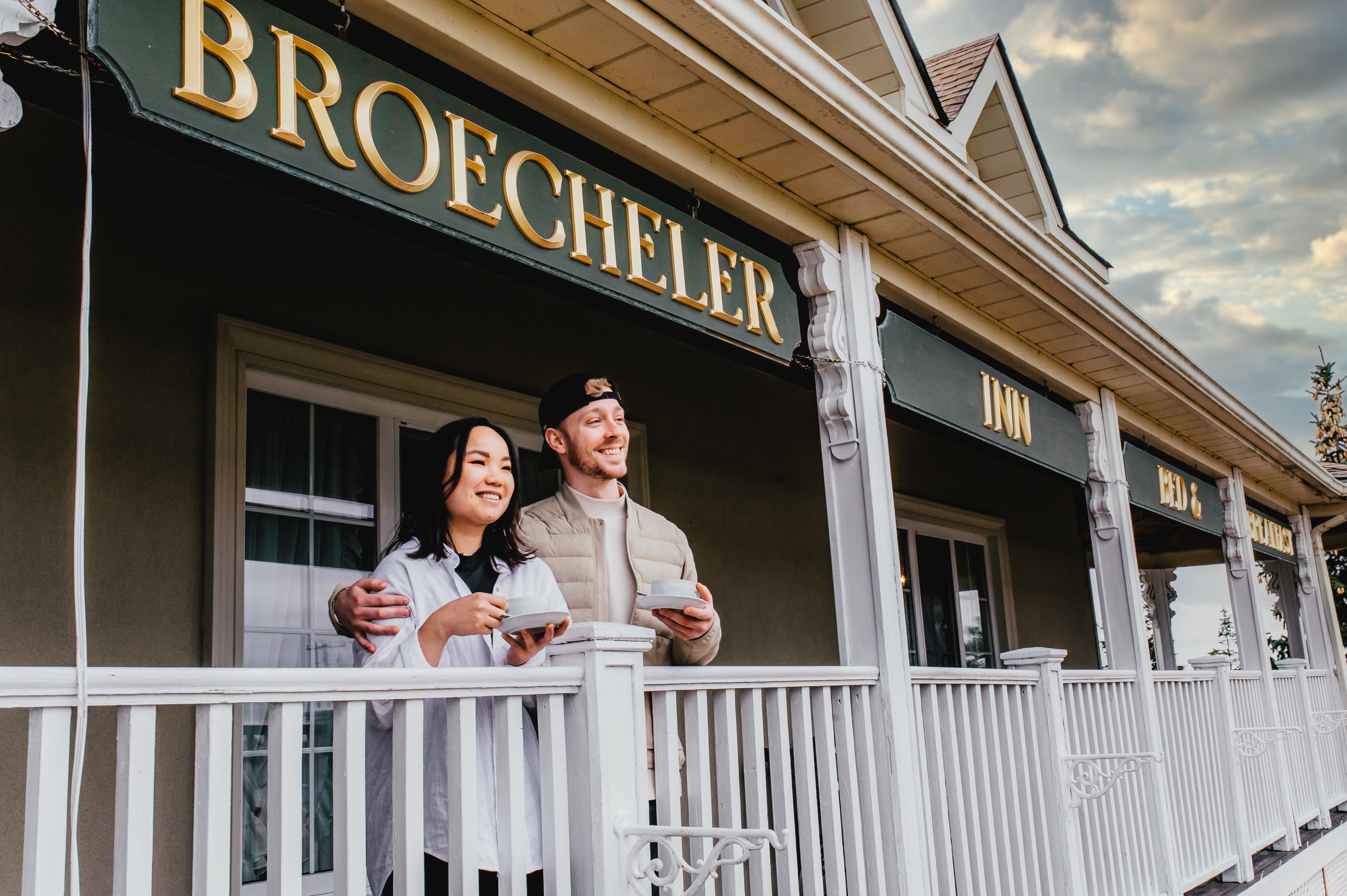 couple drinking coffee on BnB porch looking out into scenery