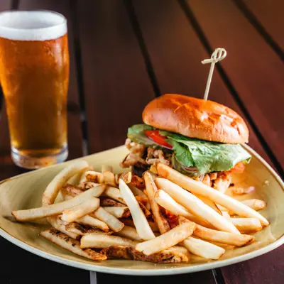 image of a burger and fries with a beer