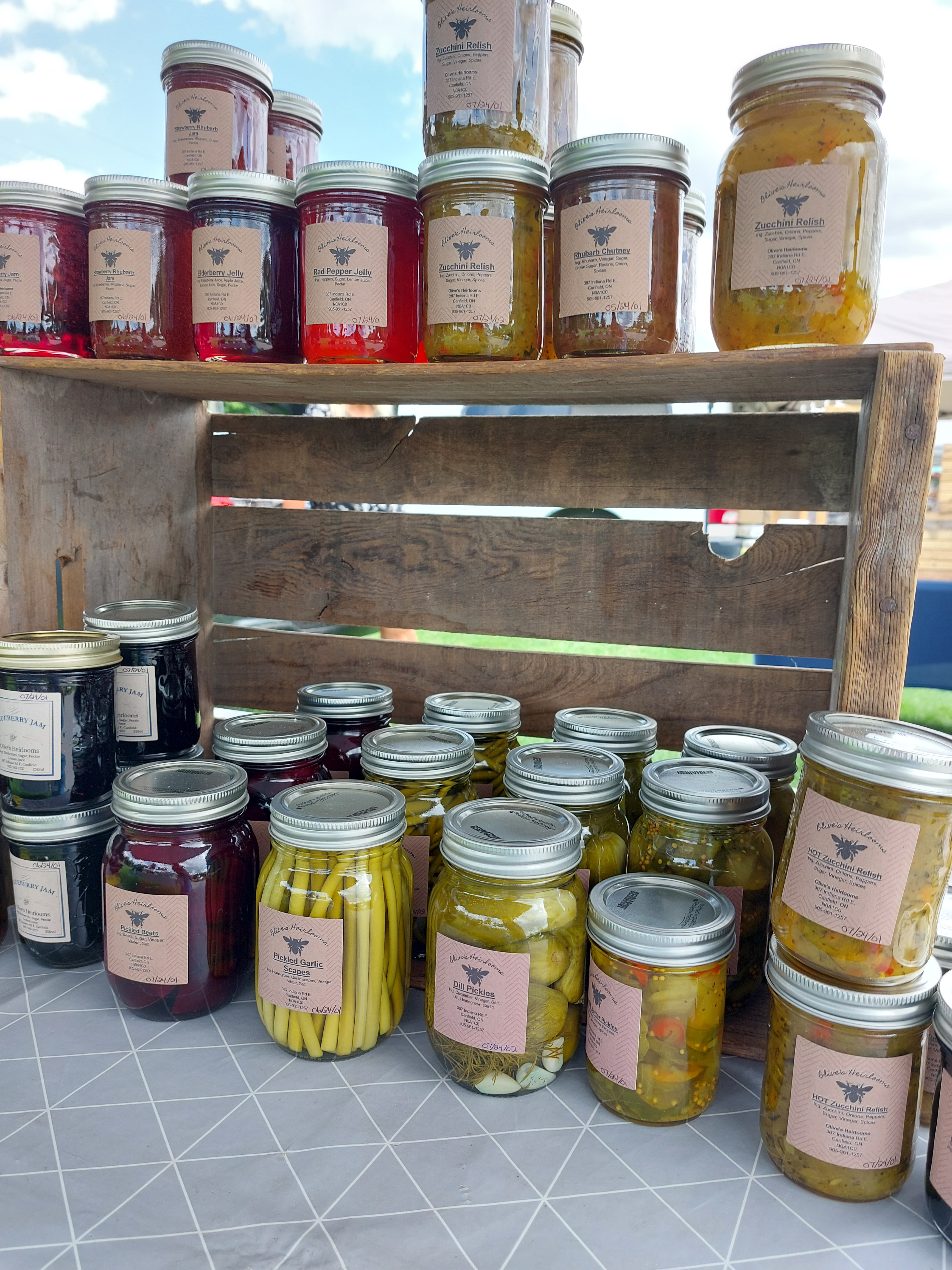 jars of preserves stacked in a wooden crate