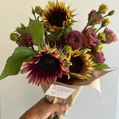 A hand holding a bouquet of flowers
