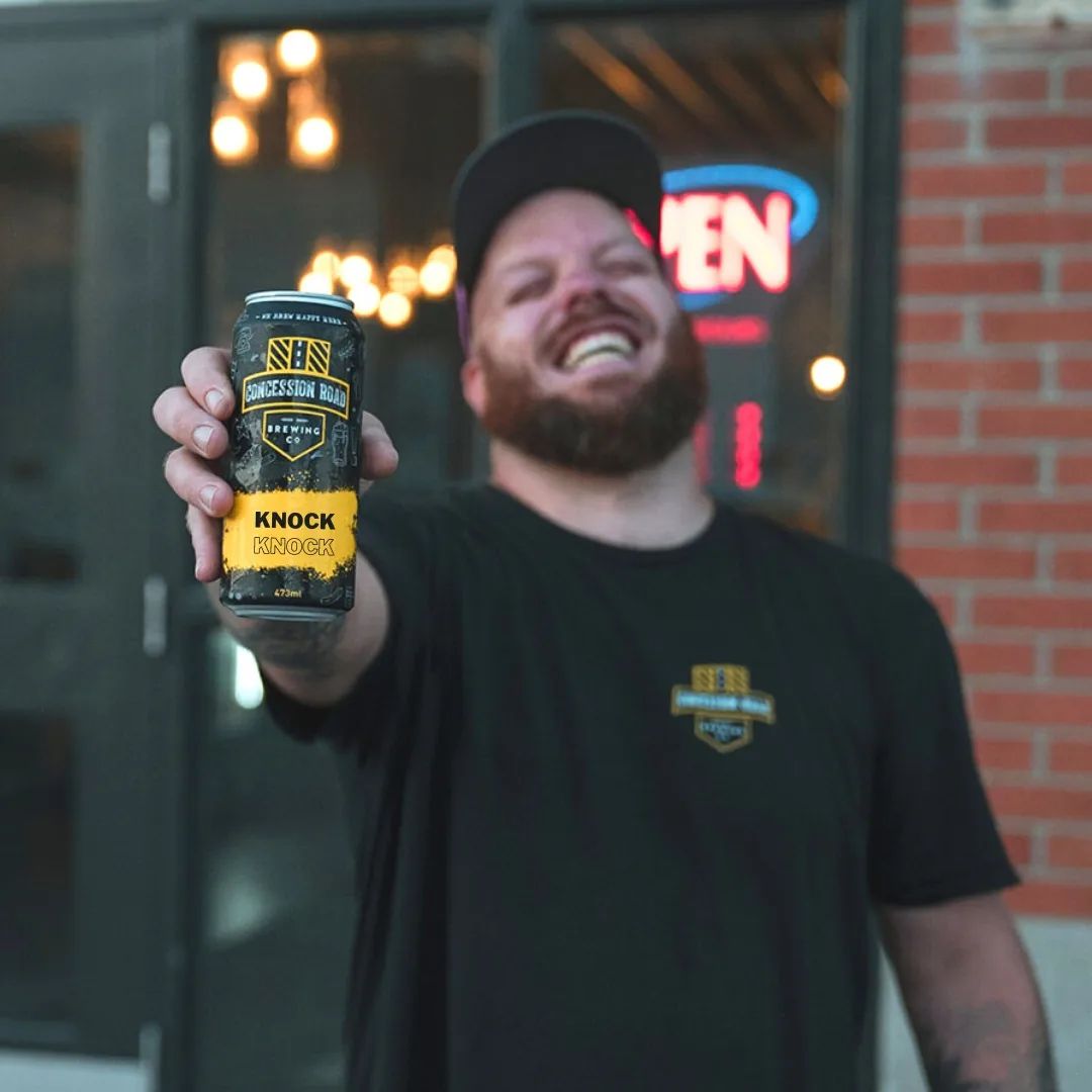 Man holding out a can of beer