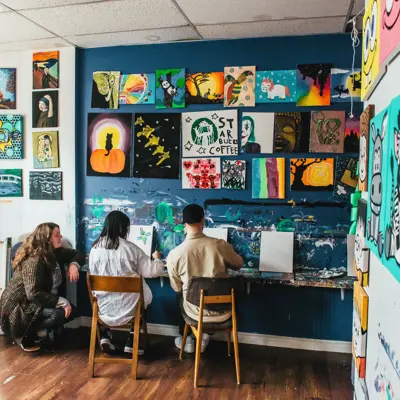 man and woman painting in an art studio