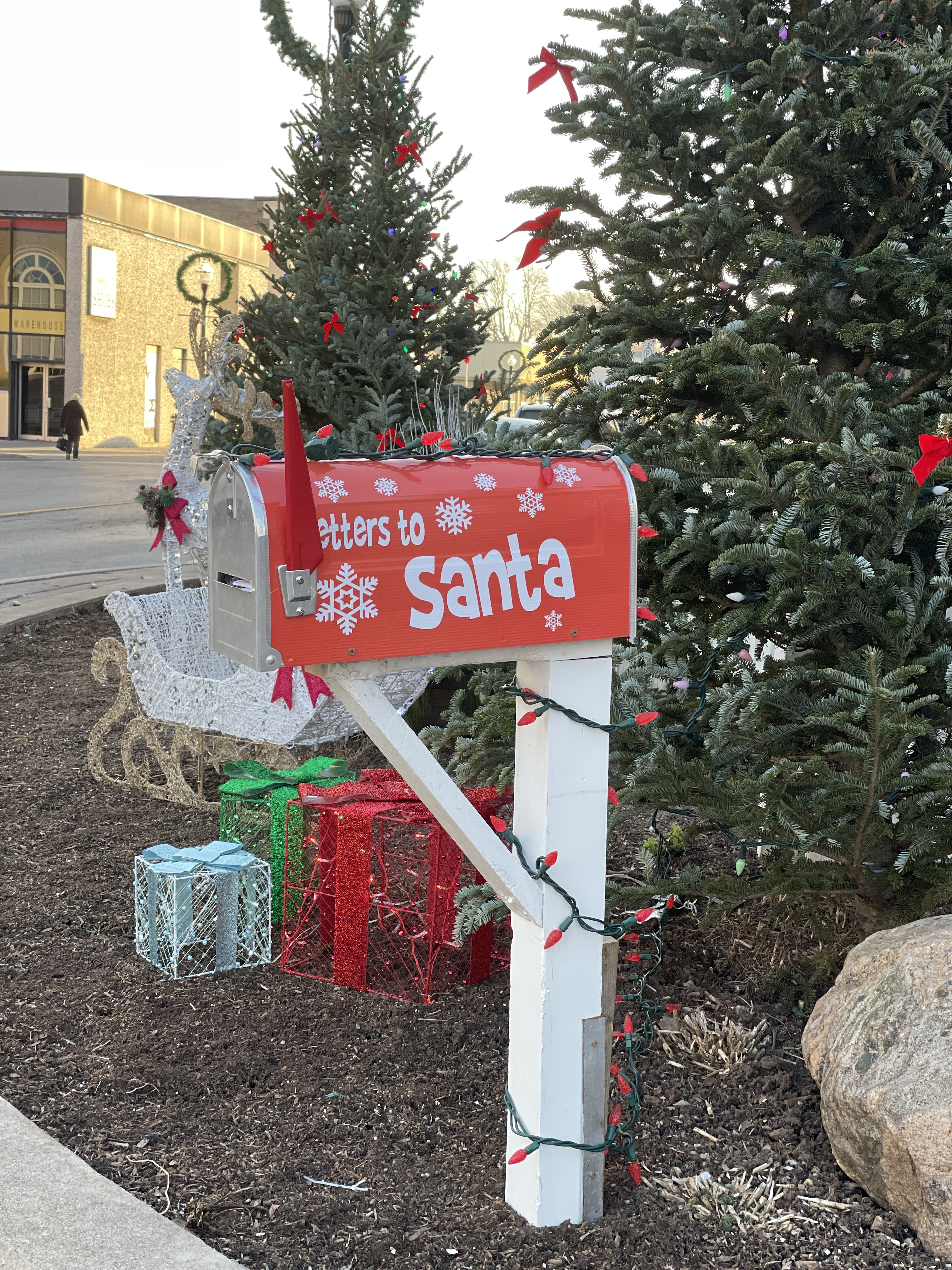 A red mailbox located in a small town for letter to Santa