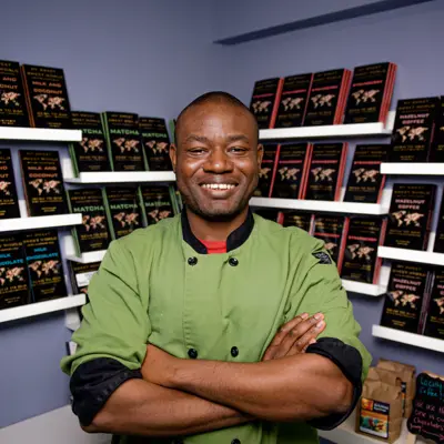 Man smiling with his arms crossed in front of chocolate