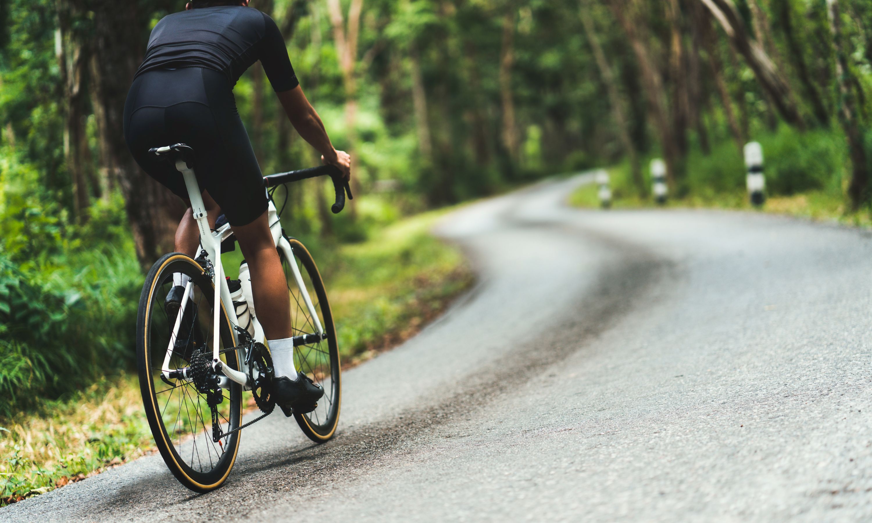 Close up of a man biking on a path