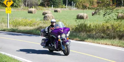 Man on purple motorcycle