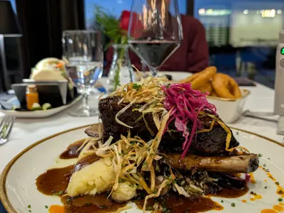 An elegant dinner table with wine glasses and gourmet meal served 