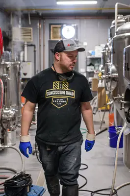 A brewmaster walks among tanks of beer