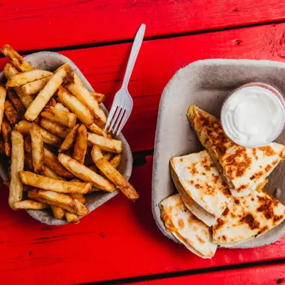 a plate of french fries and a quesadilla