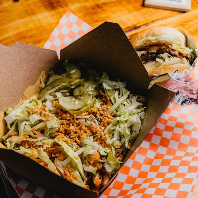 fried pickle poutine in front of a burger