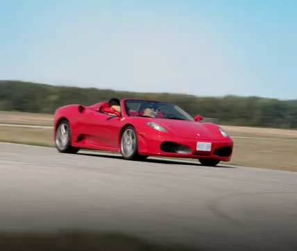 A fast red high performance car on a road