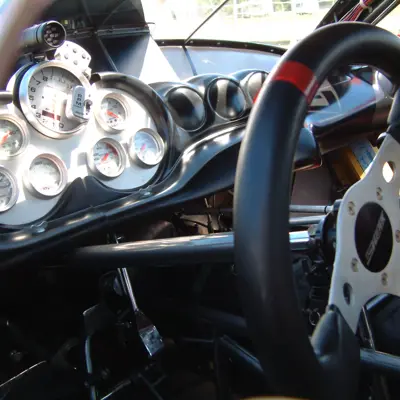 sports car interior showing steering wheel and drivers dashboard